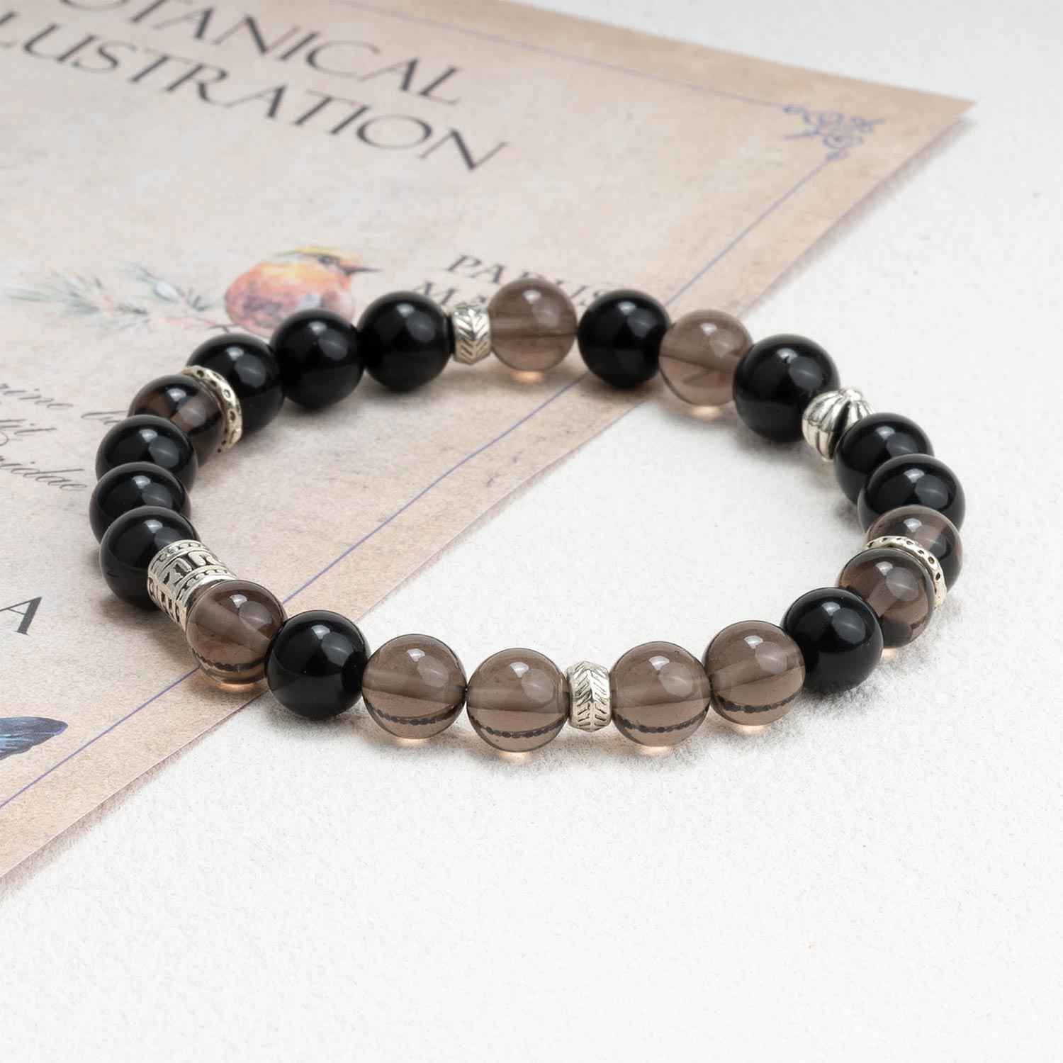 Beaded crystal bracelet with black and smoky brown stones and silver-tone spacers