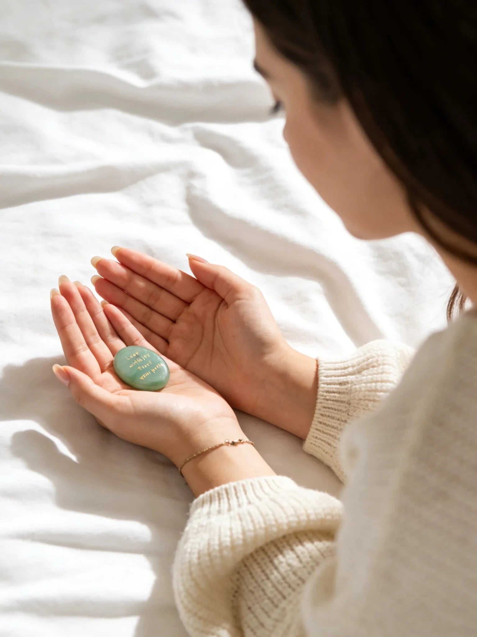 Small green Aventurine stone held in hands
