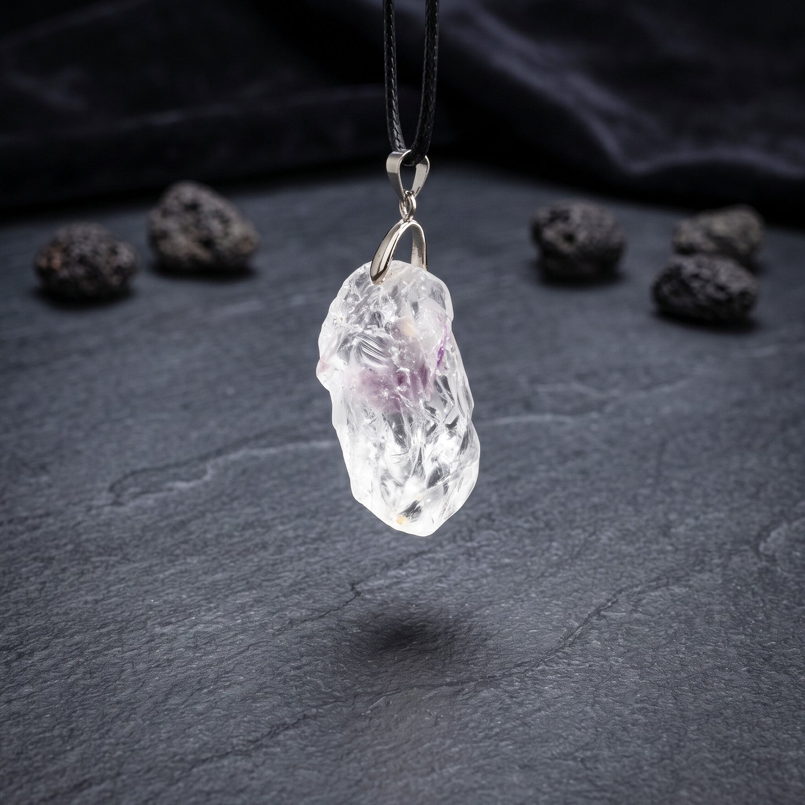 Clear quartz crystal pendant on black cord necklace with silver loop bail