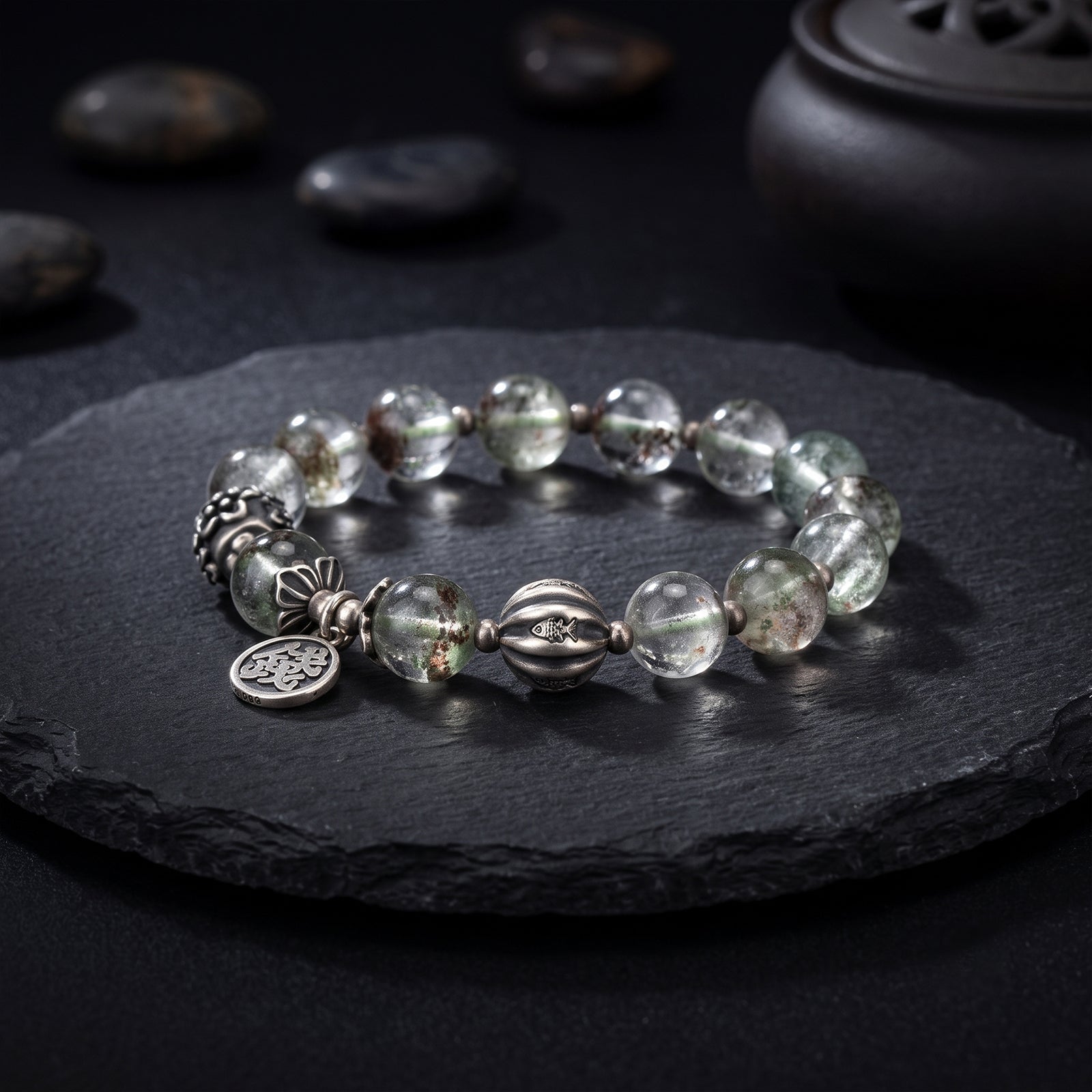 Silver bead bracelet with green-gray stones and engraved coin-style charms