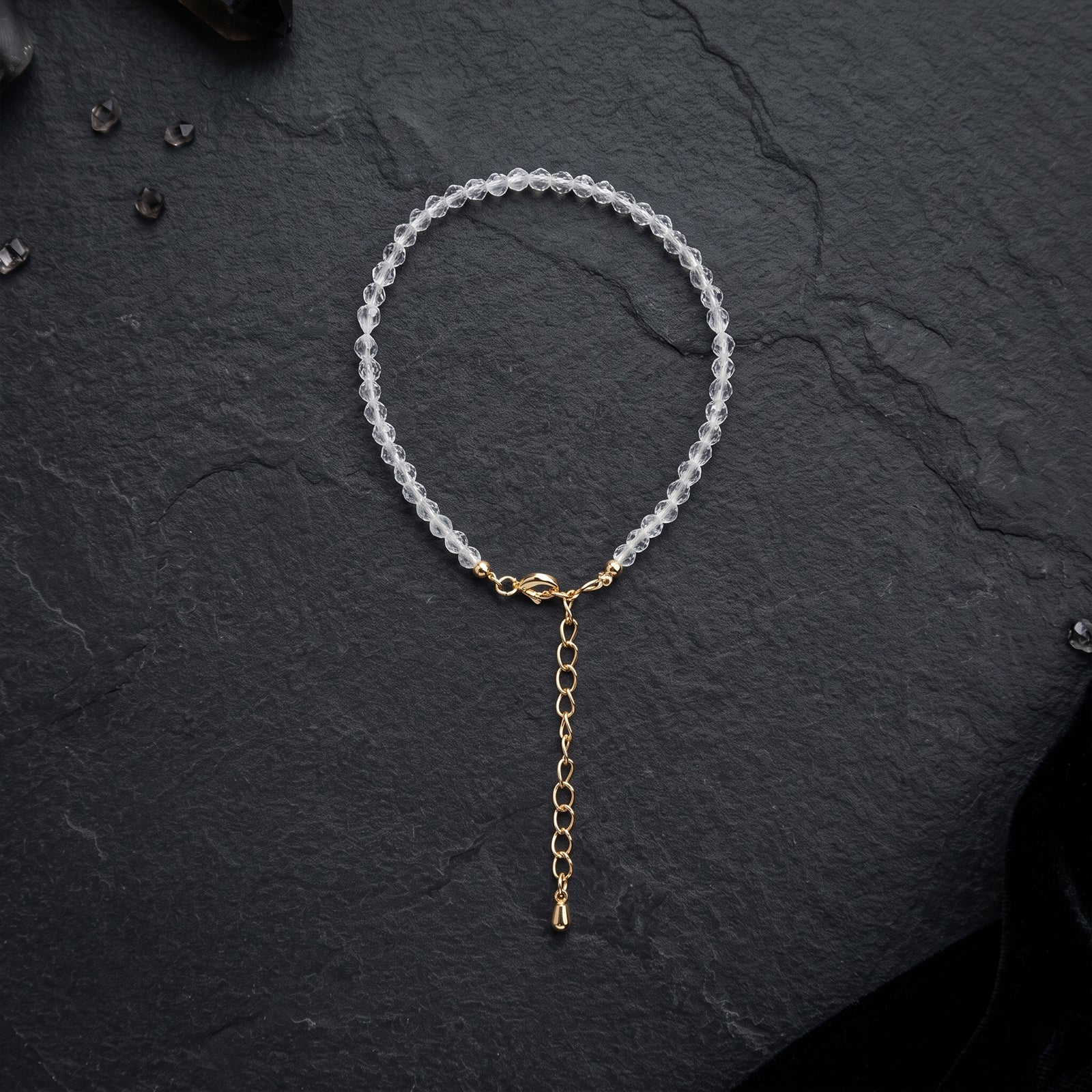 Clear quartz crystal bead bracelet with gold connector and long dangling chain