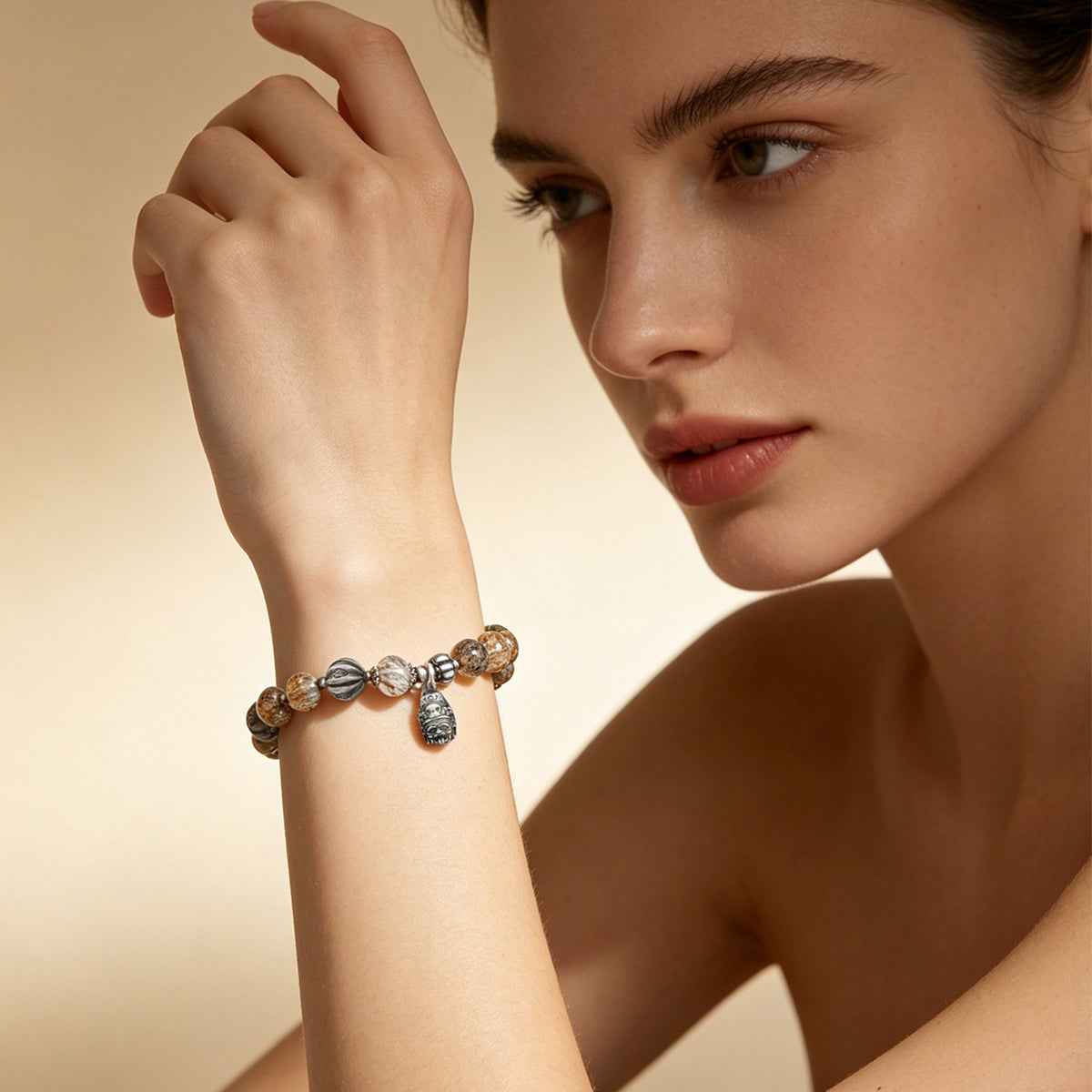 Beaded bracelet with round crystal beads and silver-tone charm accents