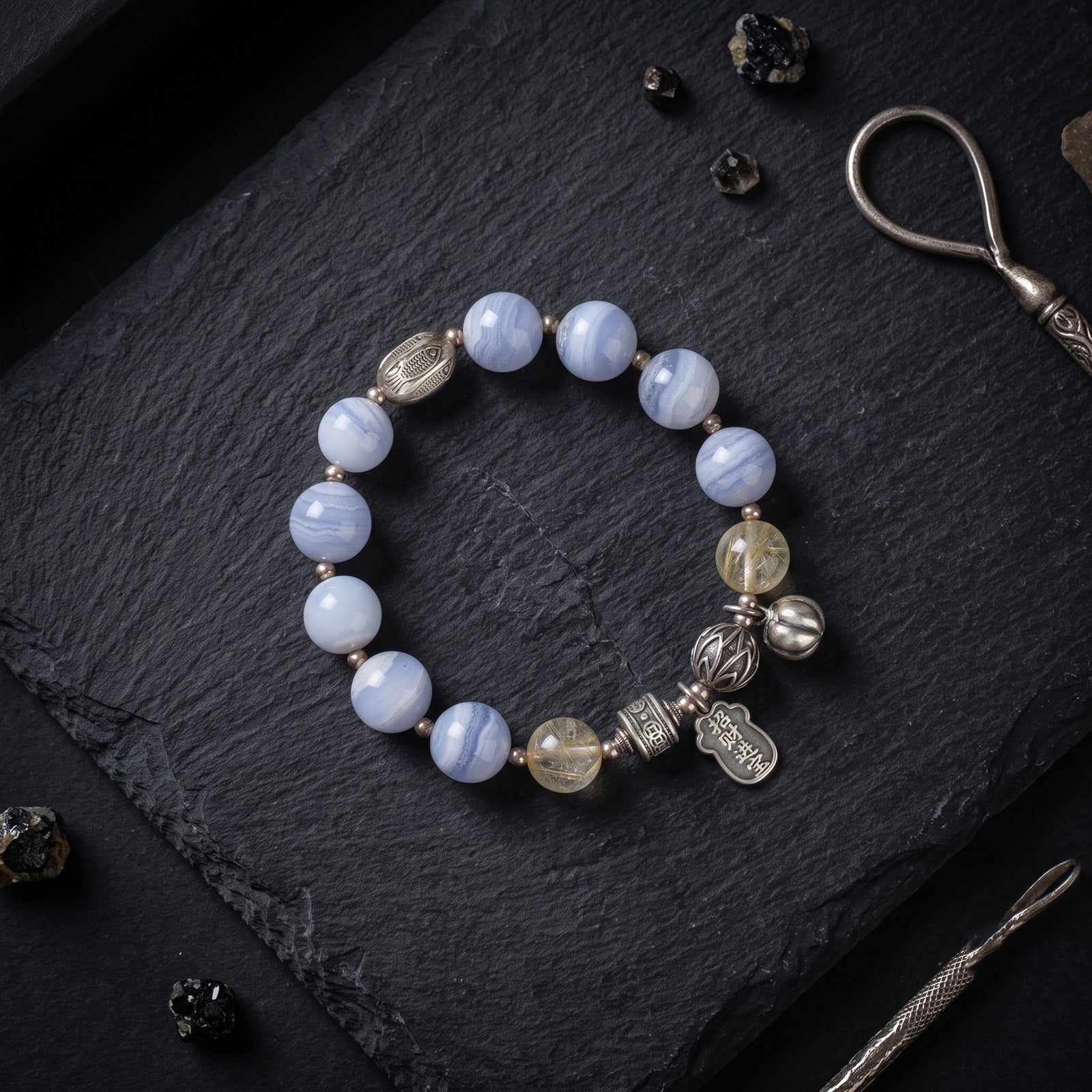 Light blue lace agate bead bracelet with silver-tone charms and gold-tone accent beads