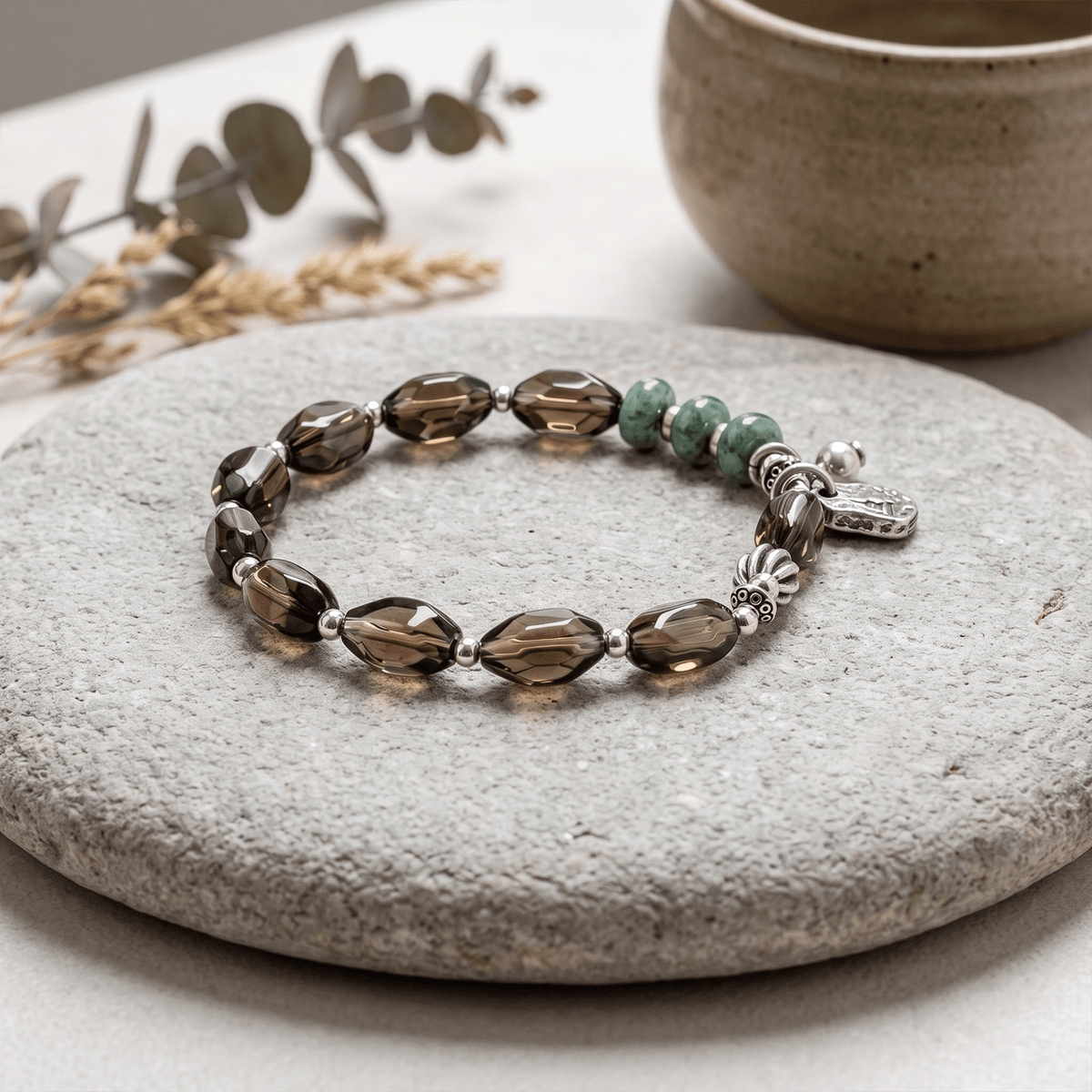 Smoky quartz and jadeite bracelet with green beads and silver deity relief charm