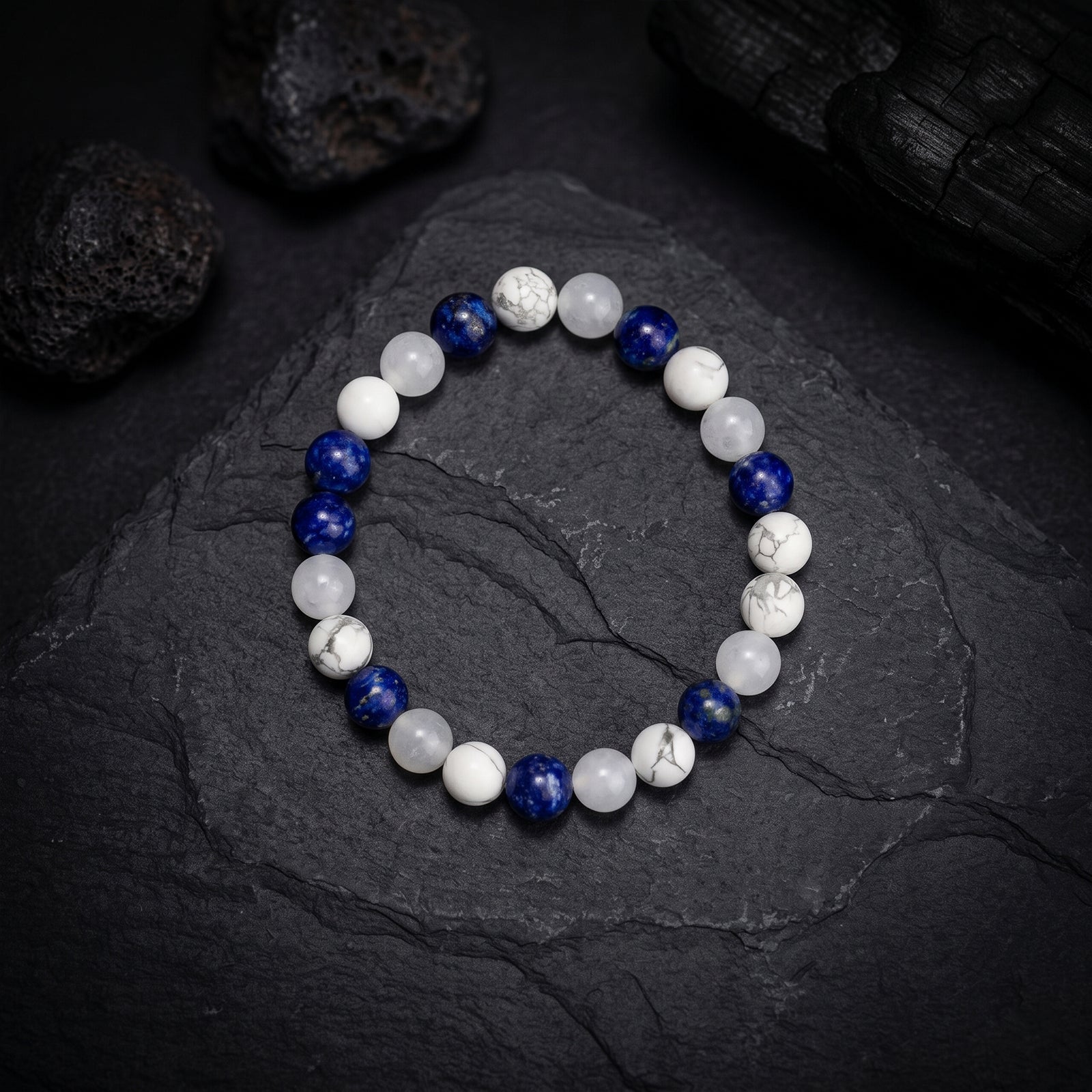 White and blue crystal bead bracelet with round stones and lapis-like accents, elastic fit