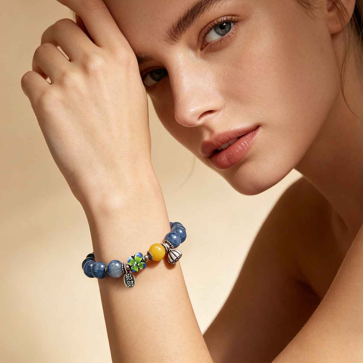Crystal bead bracelet on wrist with blue stones and multicolor charm bead accents