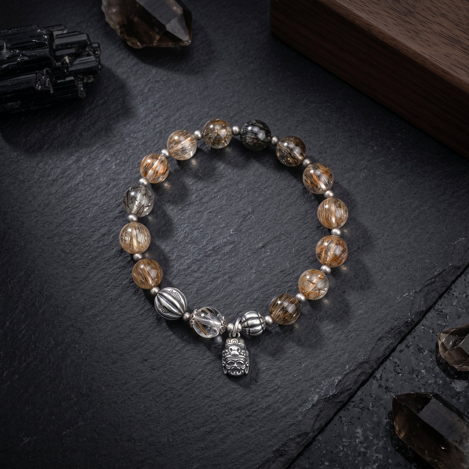 Beaded bracelet with golden-brown stone beads, silver-toned beads, and hanging charm