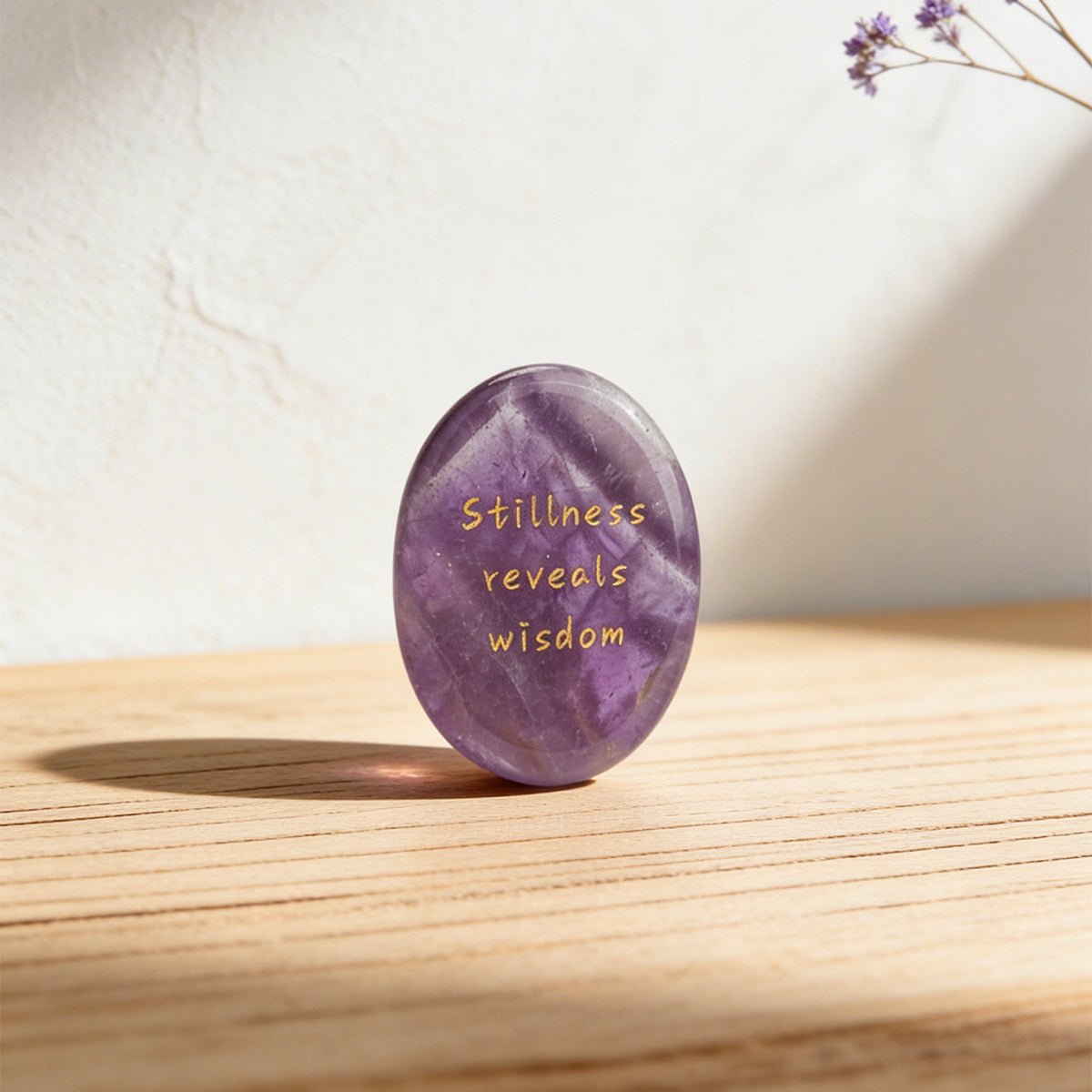 Amethyst oval stone standing upright with gold 'Stillness reveals wisdom' text