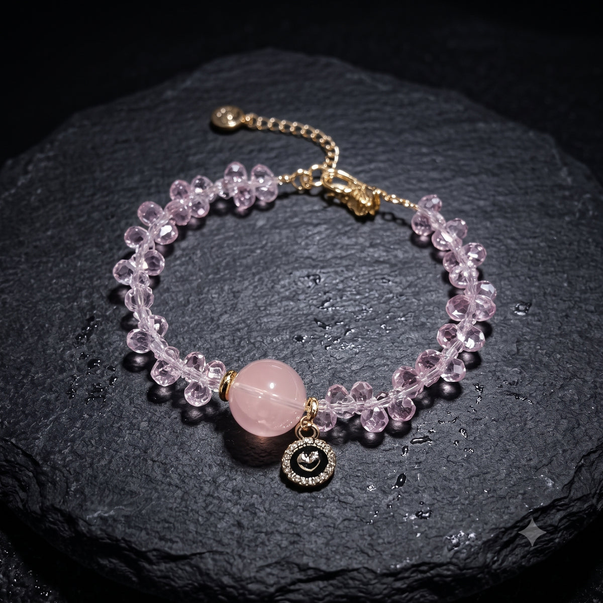 Lavender-pink faceted crystal bead bracelet with rose quartz center and gold moon-eye charm