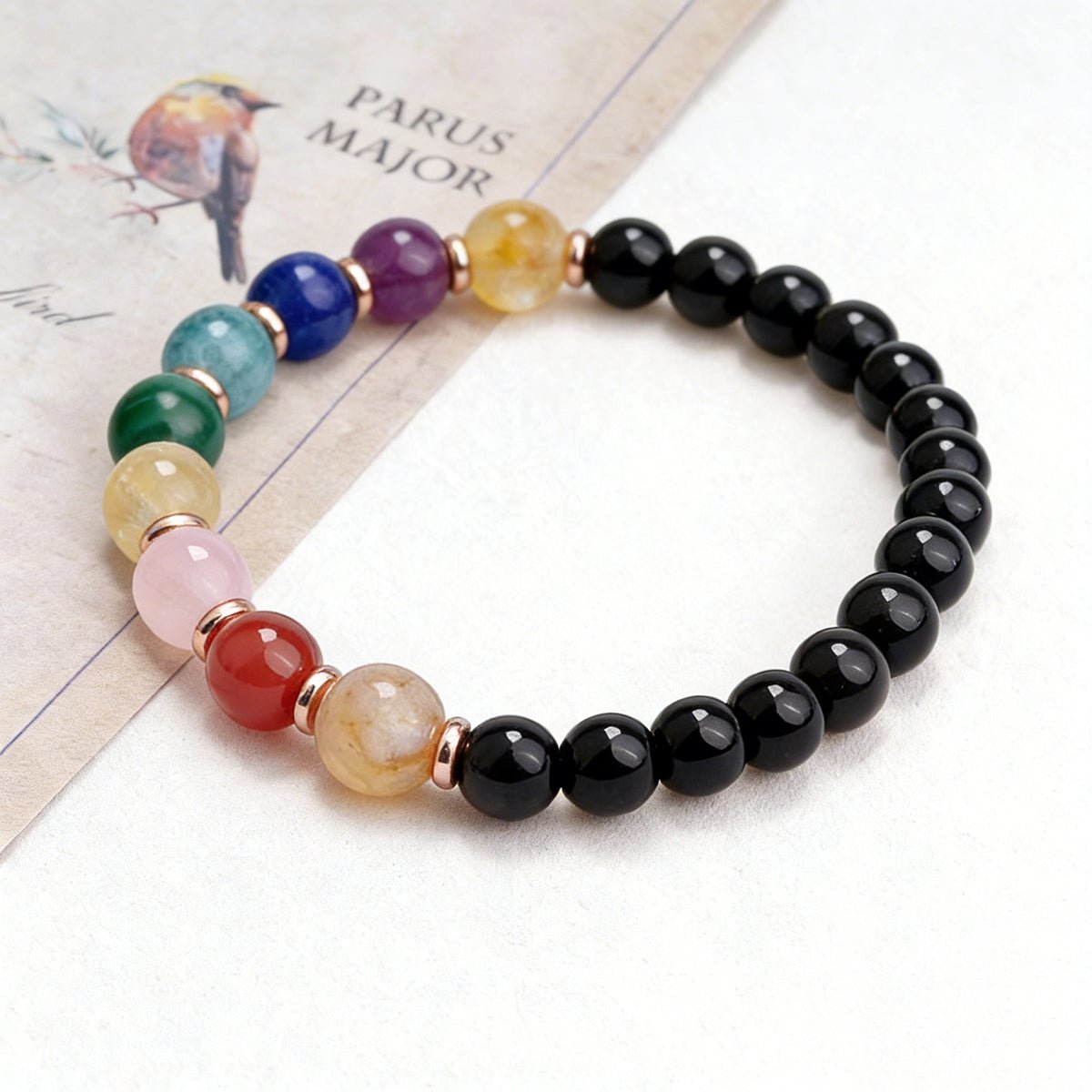 Multigemstone beaded bracelet with black round beads and colored gemstone accents