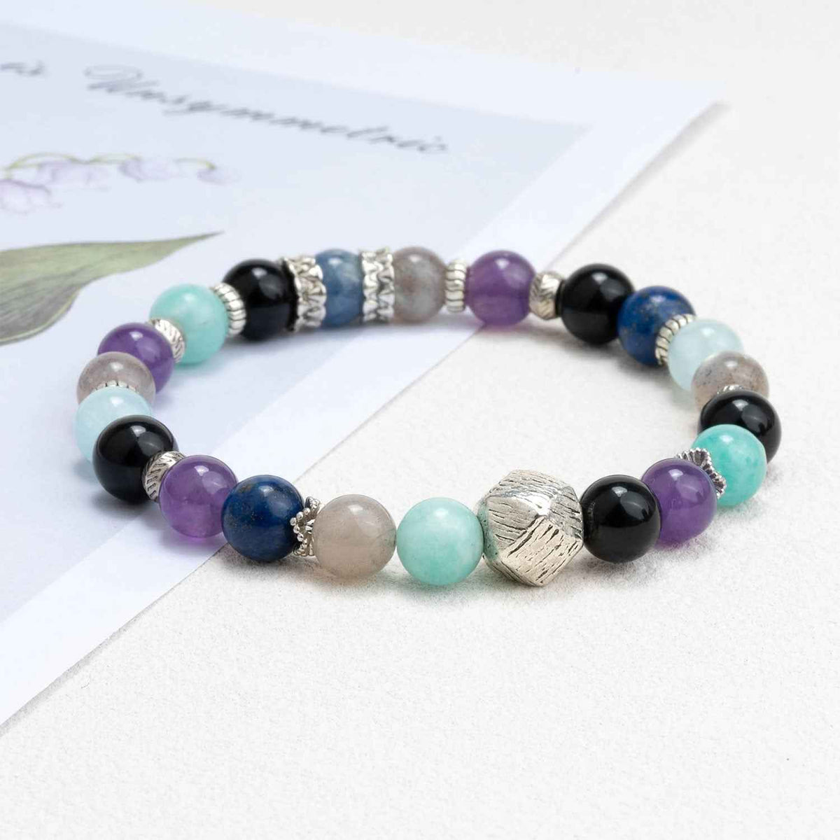 Multicolor crystal beaded bracelet with black, purple, turquoise beads and silver spacers
