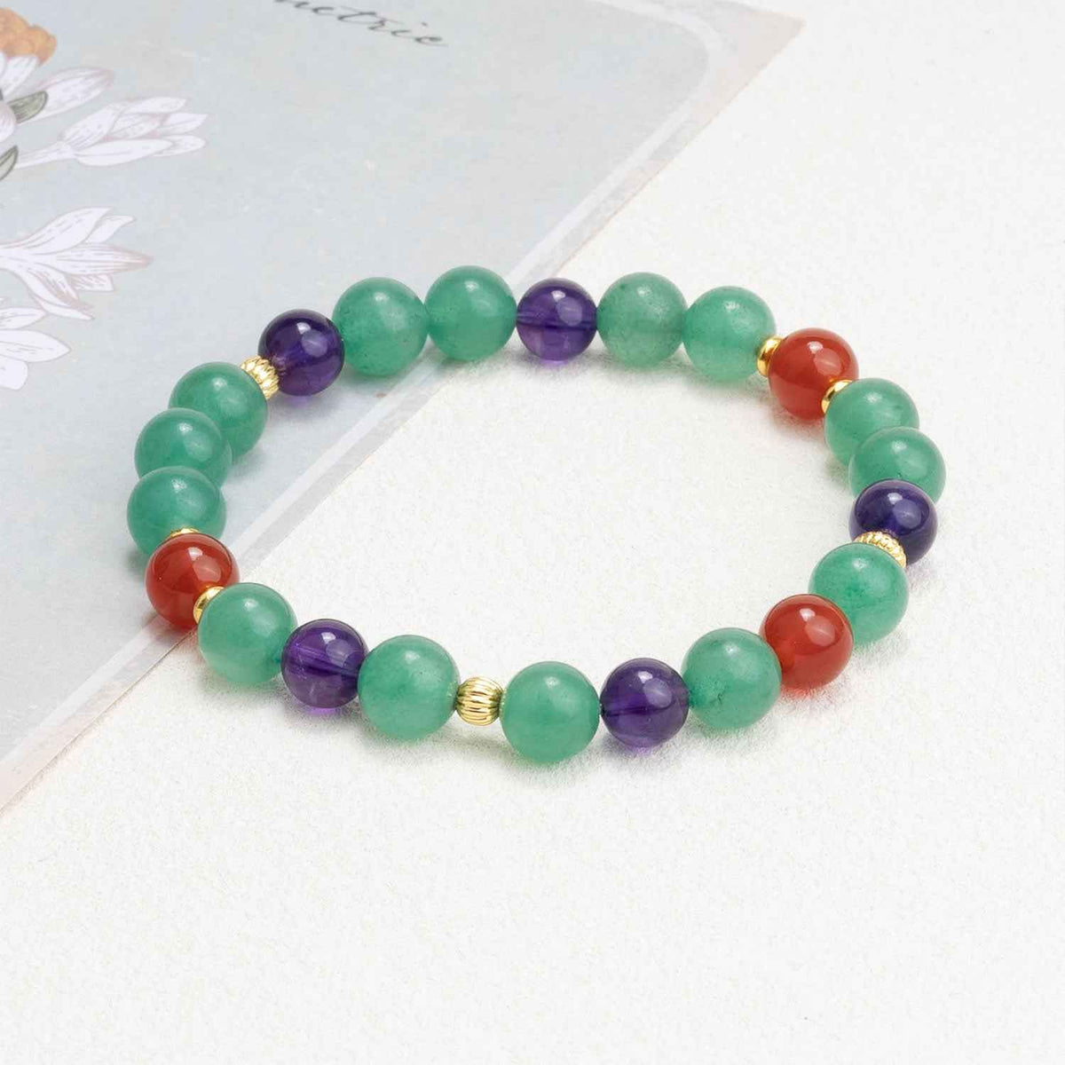 Heart chakra crystal bead bracelet with green, purple, red stones and gold-tone spacers