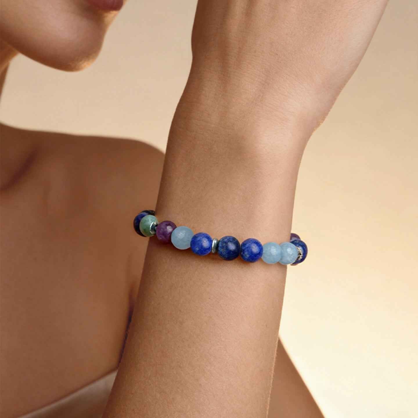 Closeup of wrist wearing Amesha Energy Throat Chakra Truth Crystal Bracelet - Blue Labradorite and mixed gemstone beads for self-expression