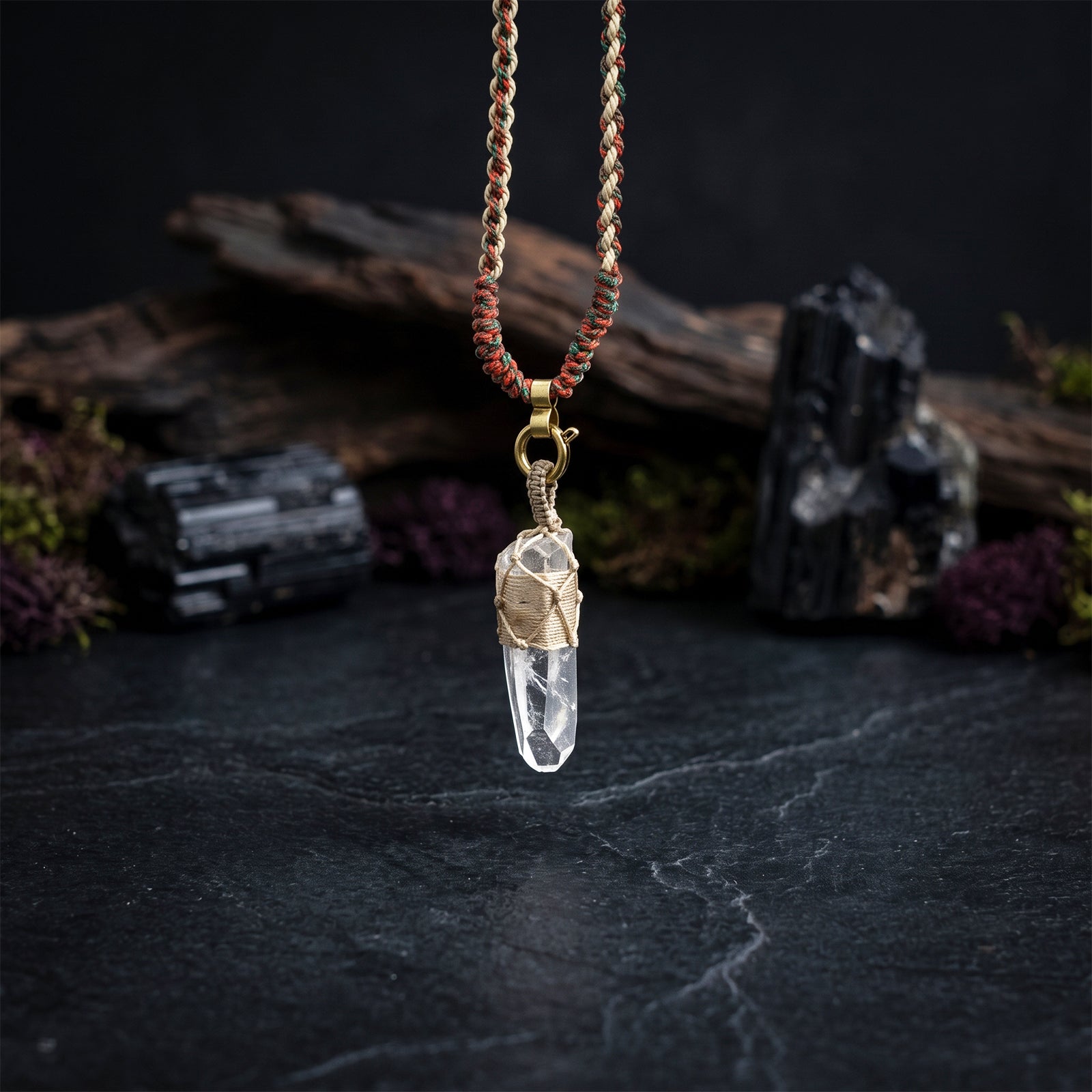 Quartz crystal wrap pendant with braided cord and gold-toned loop, faceted clear crystal