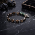 Smoky quartz bead bracelet with green jade accents and silver charm toggle clasp