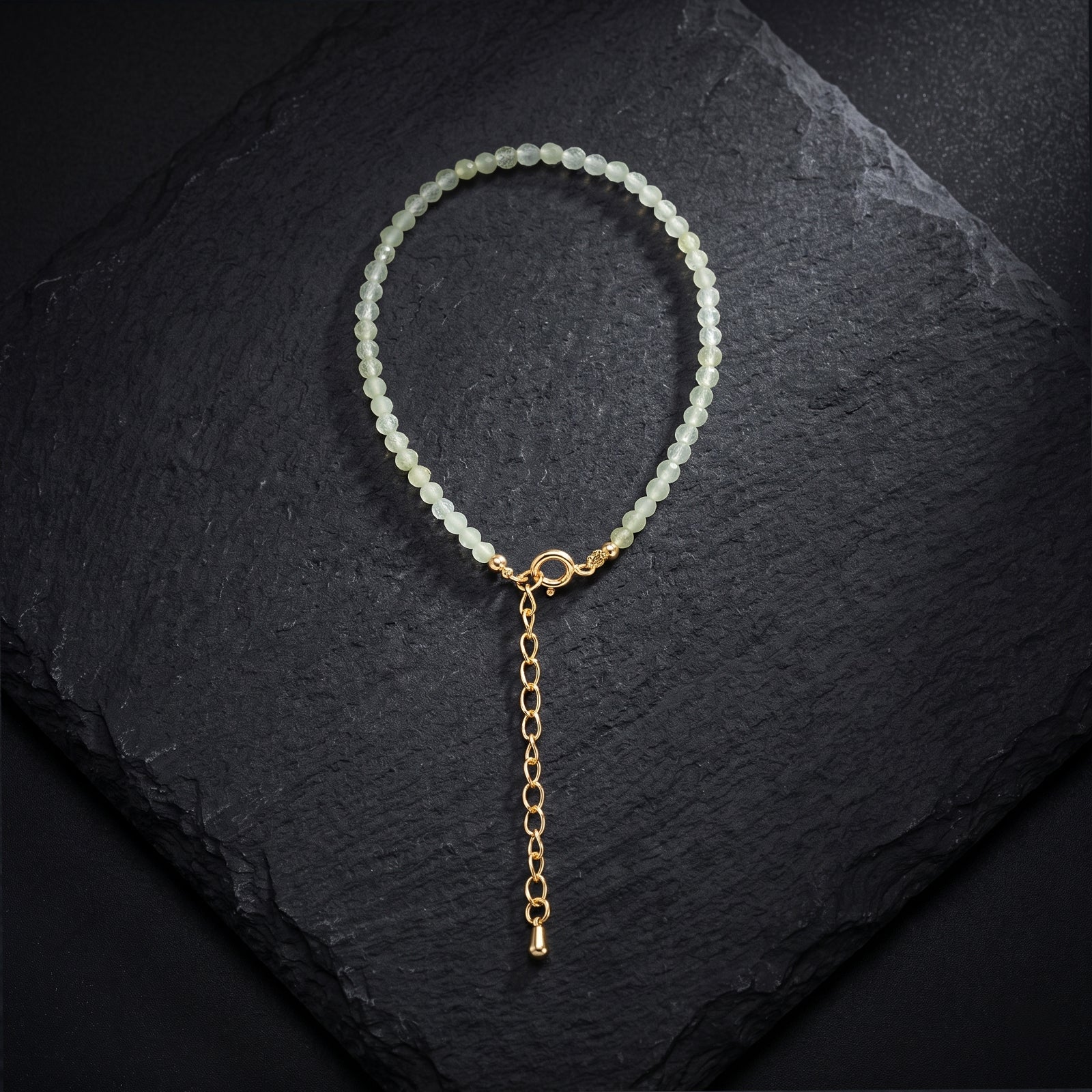 Light green crystal bead bracelet with gold toggle clasp and dangling chain
