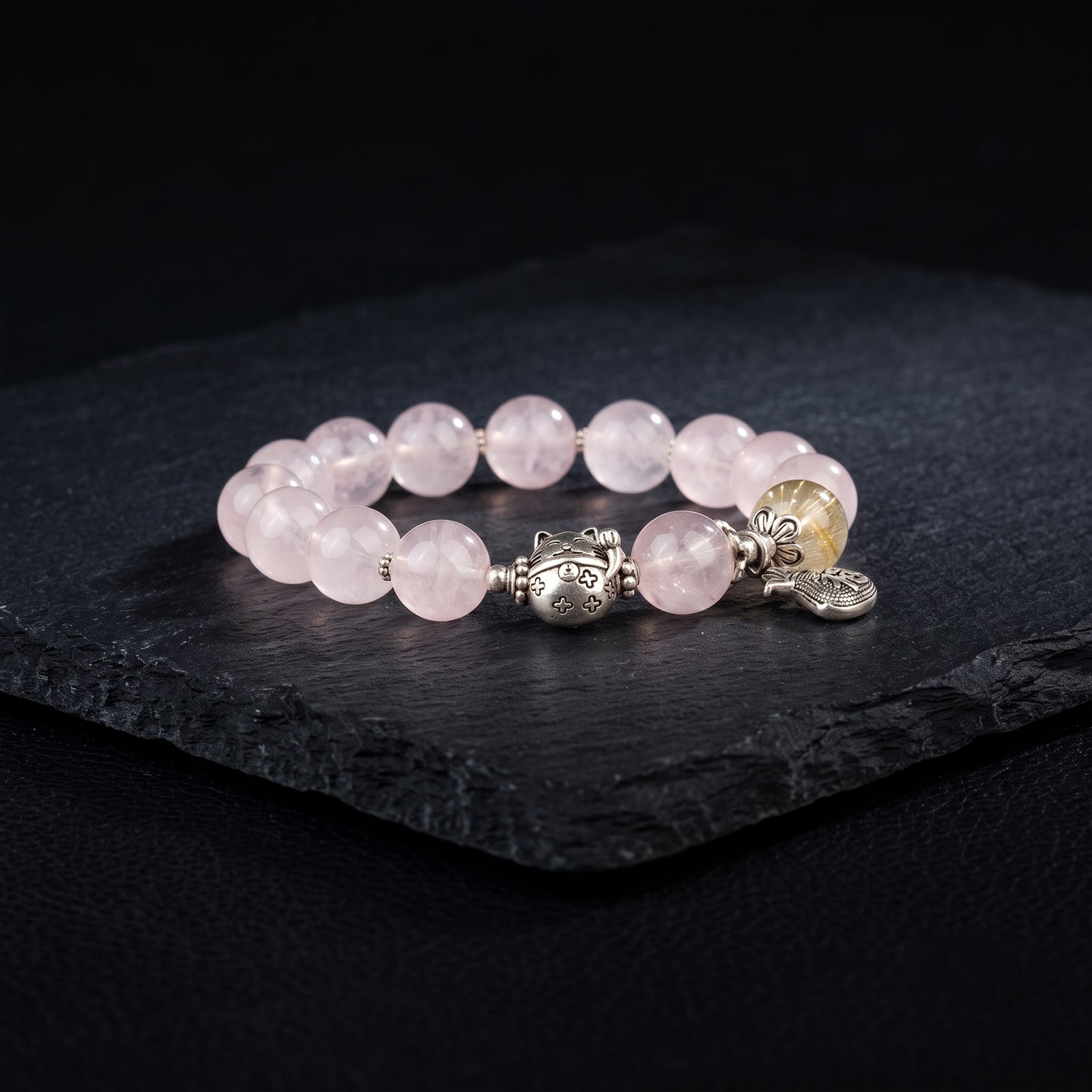 Rose quartz bead bracelet with silver-tone toggle clasp and charm dangle