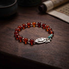 Tibetan Protection · Red Amber & Lucky Elephant Bracelet