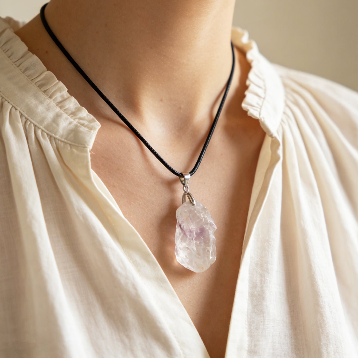 Clear quartz pendant on black cord necklace with silver bail