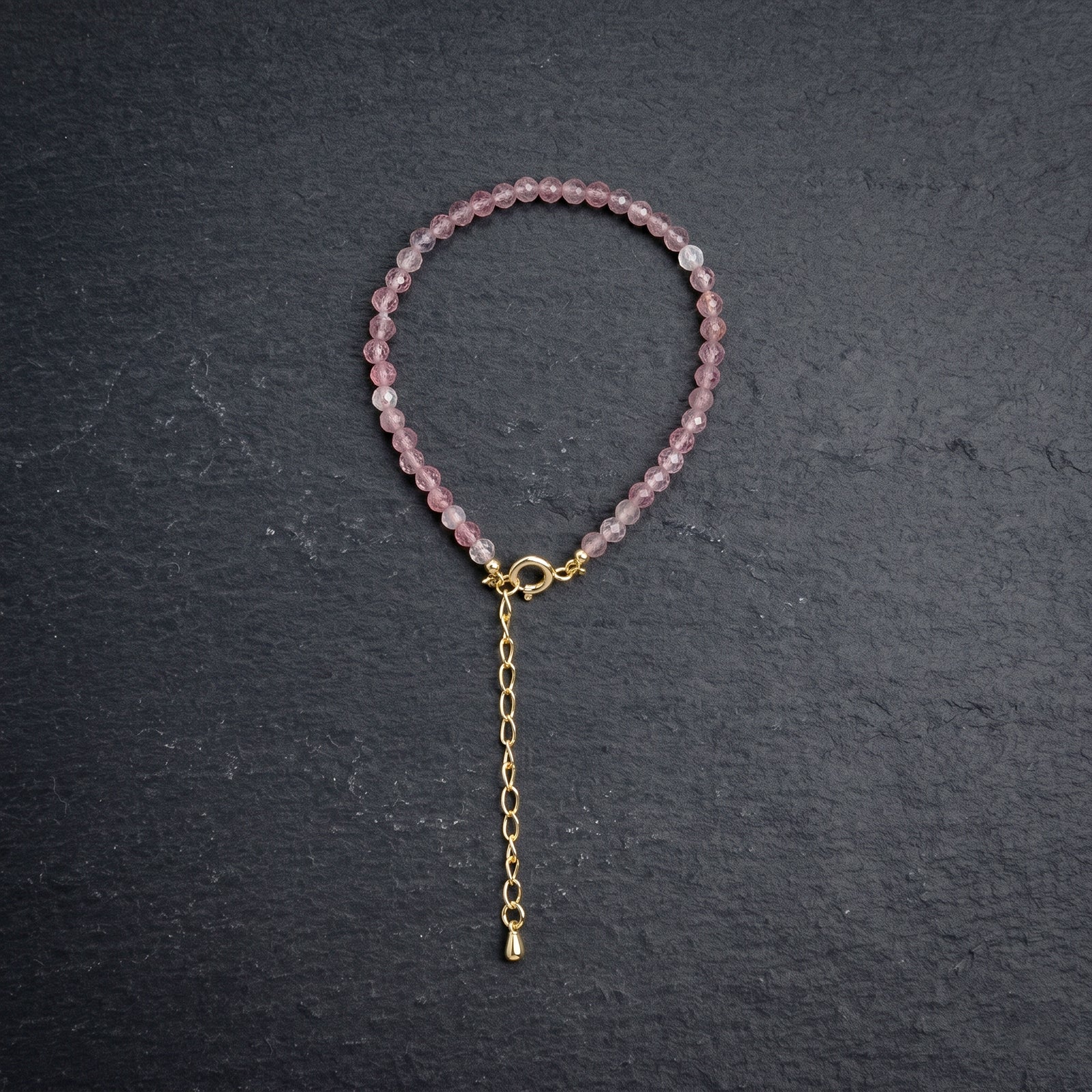 Pink bead bracelet with gold chain tassel and clasp loop, round stone beads