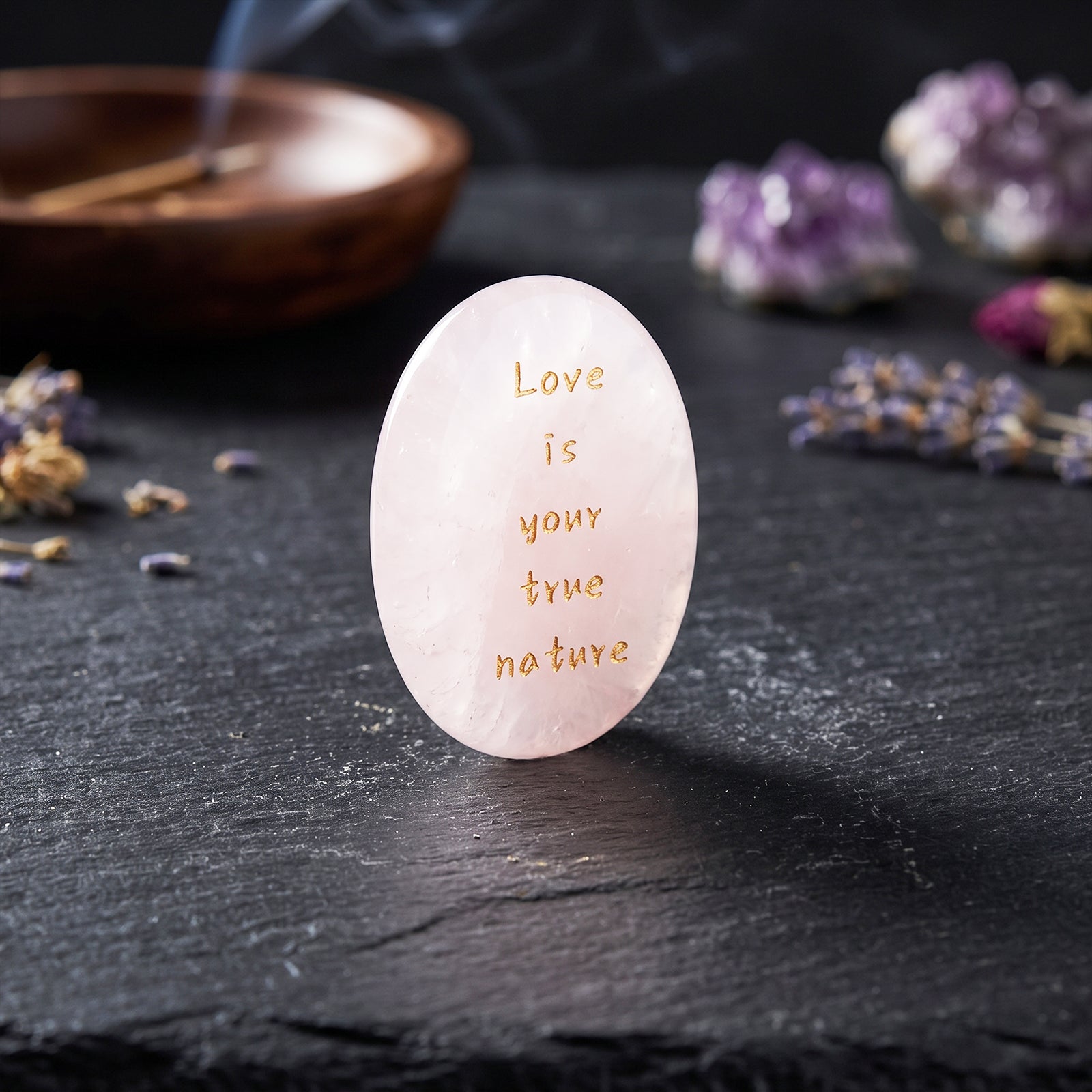 Oval rose quartz healing stone with gold engraved message: Love is your true nature