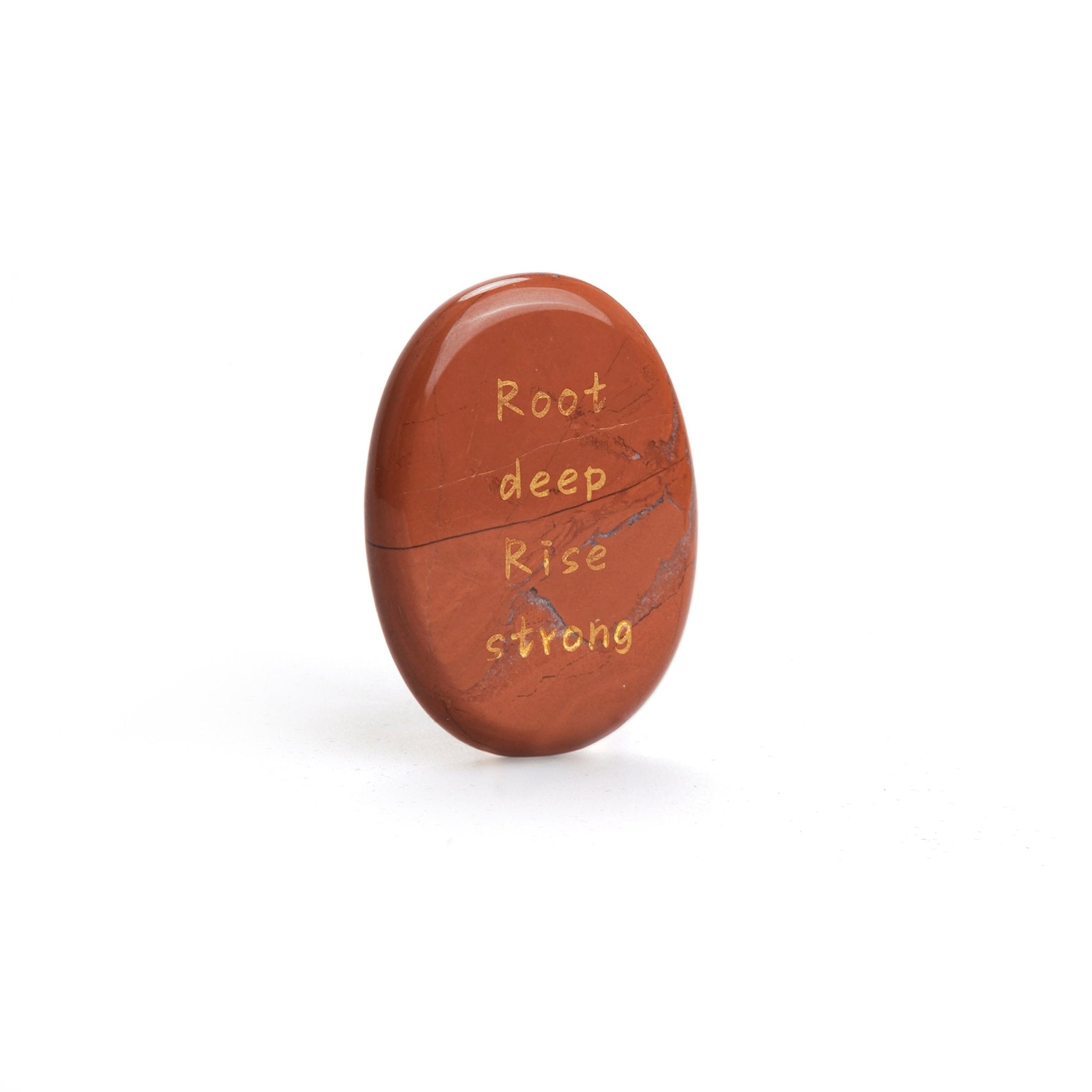 Red jasper oval stone with carved text: Root deep, Rise strong