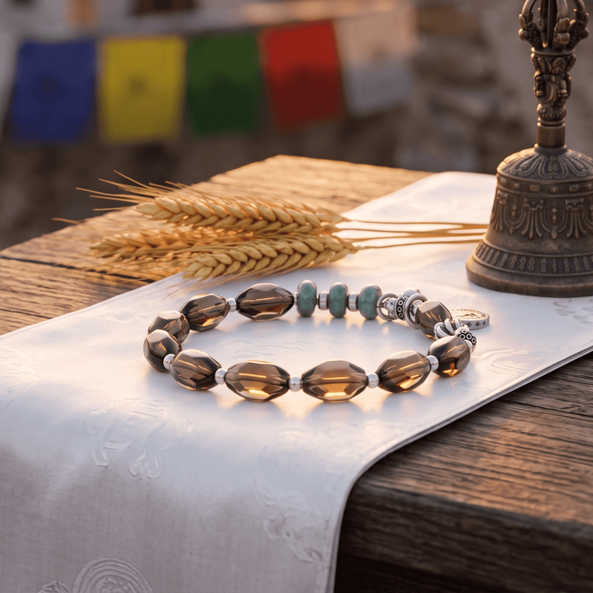 Smoky quartz bead bracelet with green jade beads and silver deity relief charm