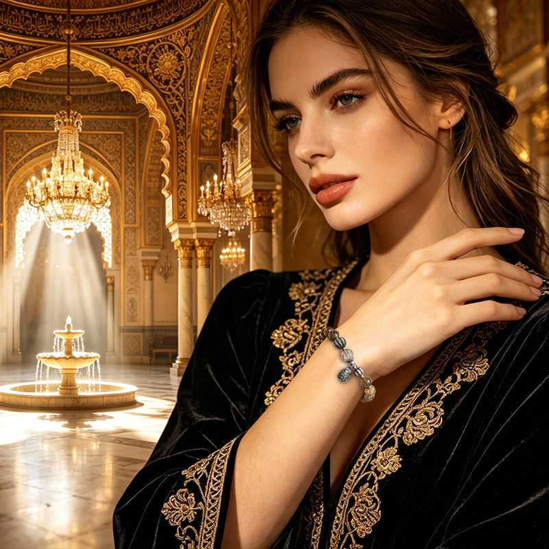 Woman wearing a crystal energy bracelet and a black gold-embroidered robe in an ornate room.