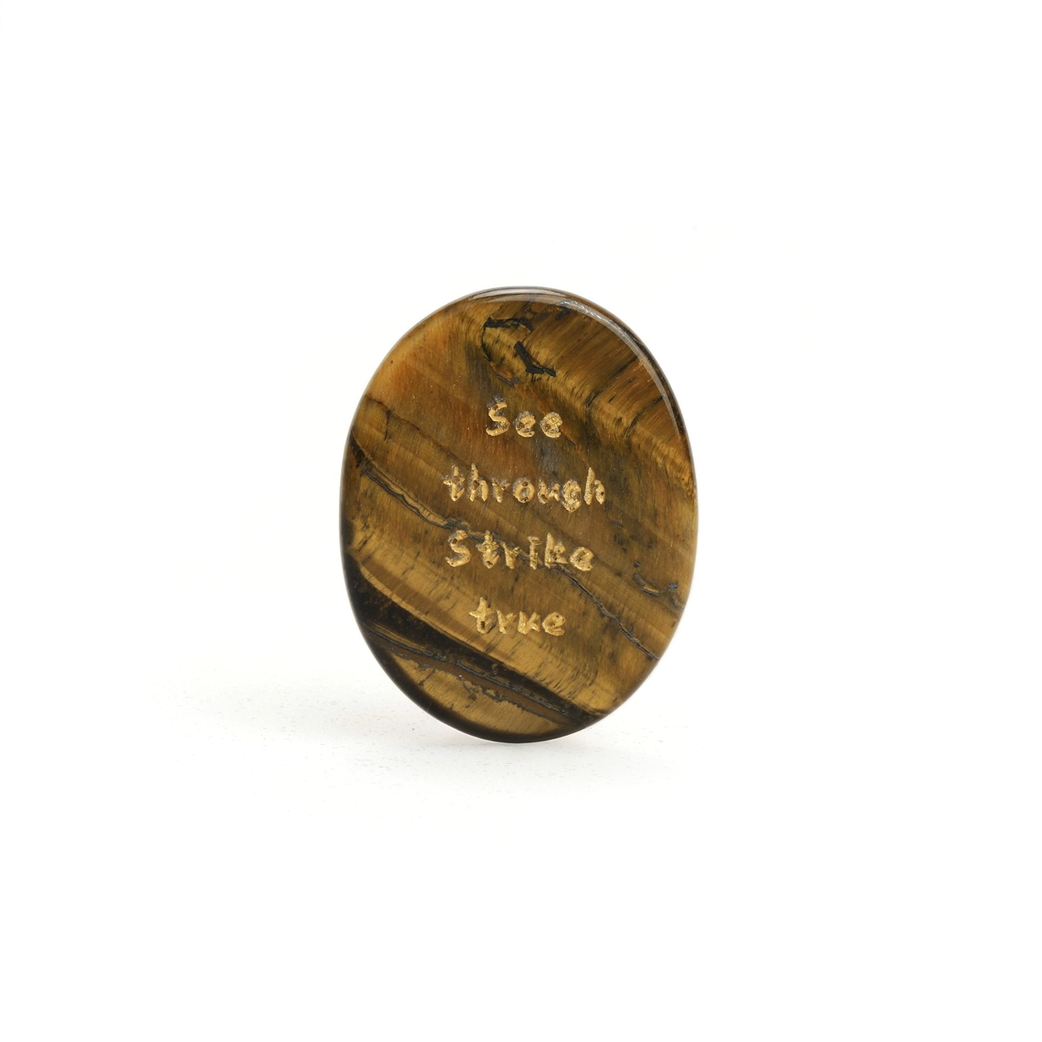 Oval tiger’s eye stone, gold-brown with engraved text across the face