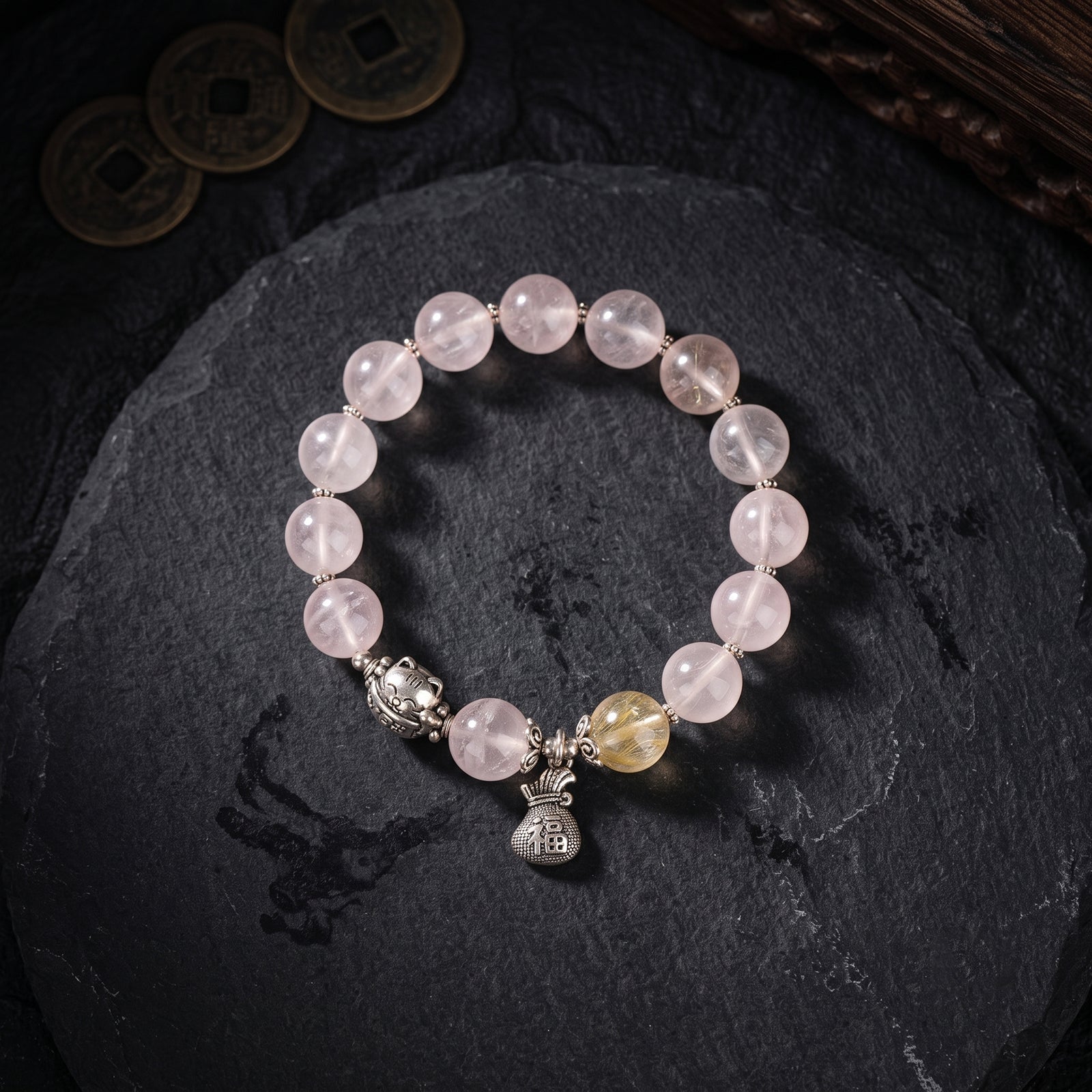 Rose quartz bead bracelet with silver-tone charm cluster and 3 dangling charms