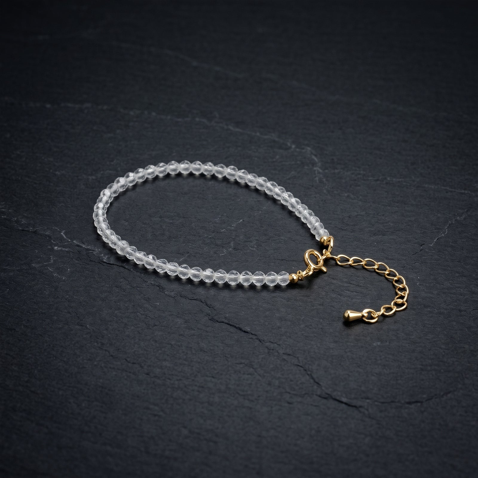 Clear quartz crystal bead bracelet with gold clasp and short chain extender