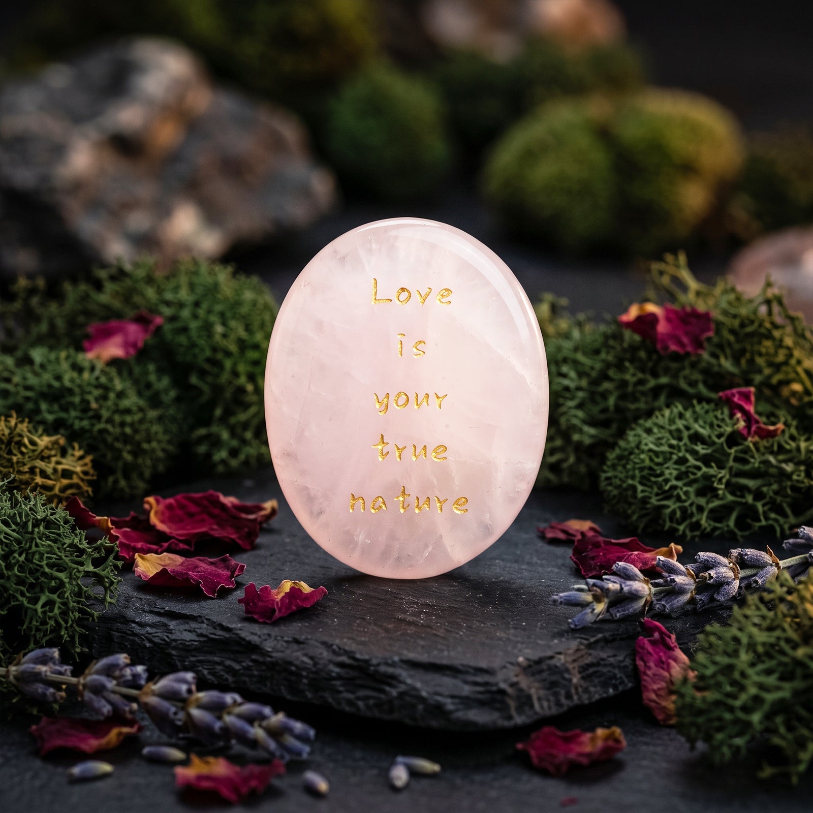 Rose quartz healing stone with gold engraving reading Love is your true nature
