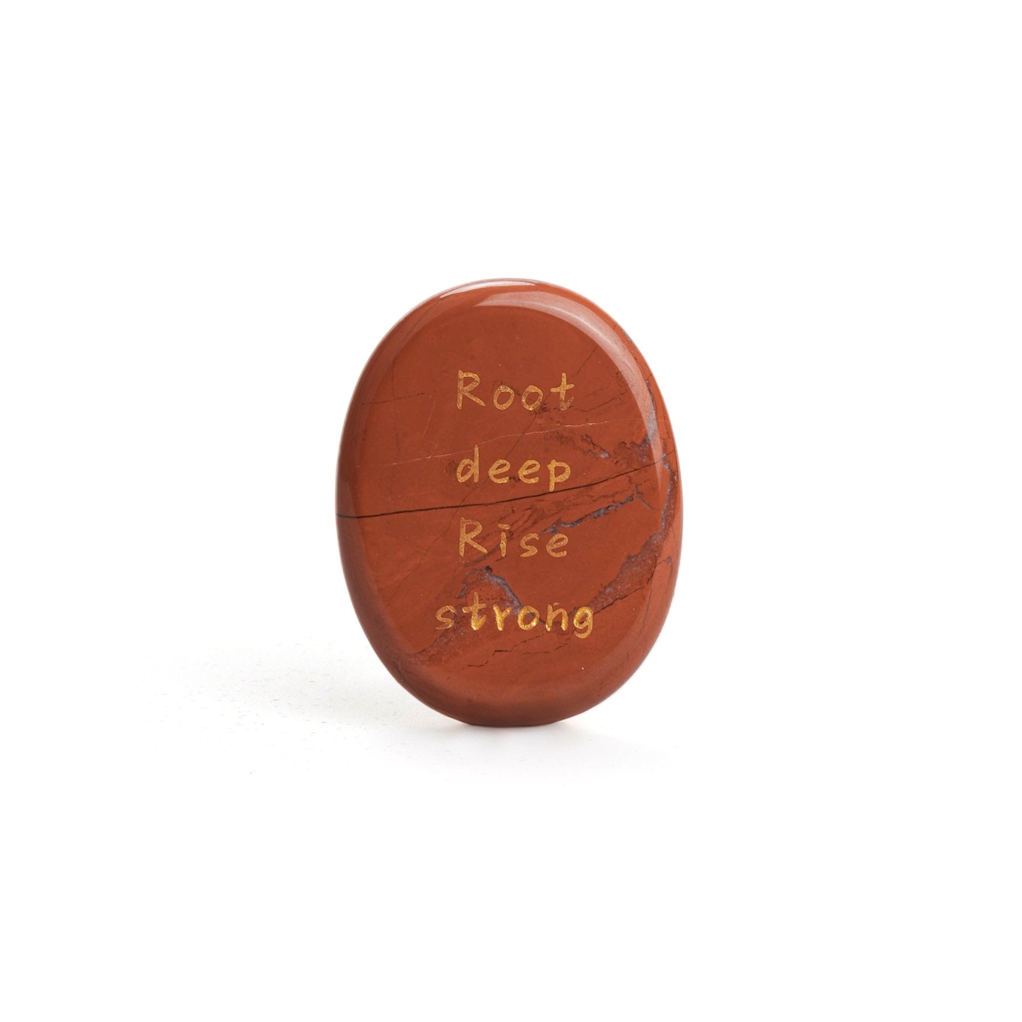Red jasper oval stone with carved text: Root deep Rise strong