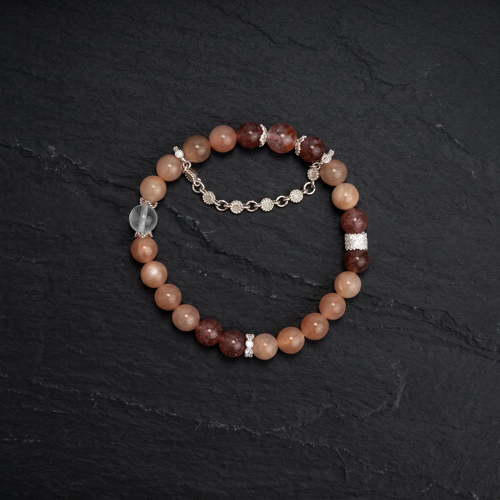 Sacral chakra crystal bracelet, round peach beads with darker red-brown accents and teardrop charm