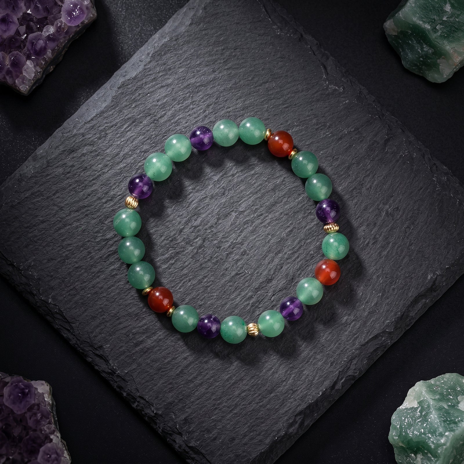 Gemstone beaded bracelet, green and purple beads with red highlights and gold-tone spacers