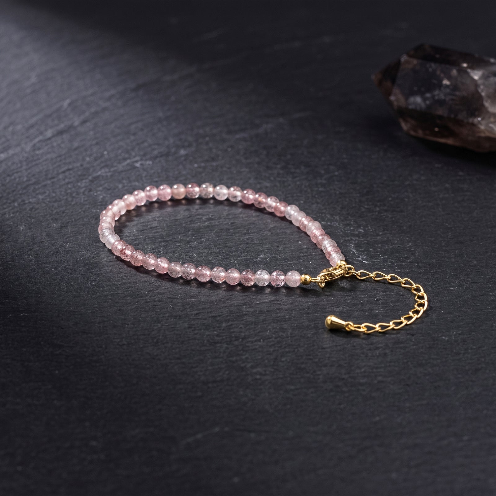 Pink bead bracelet with gold clasp chain and round gemstone beads