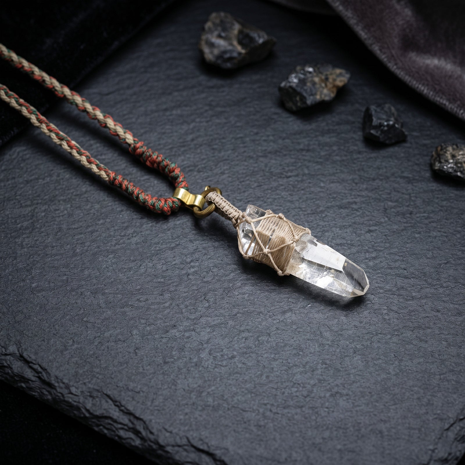 Quartz point pendant necklace with braided cord and gold-toned hardware, clear crystal