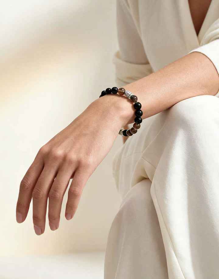 Amesha Energy Root Chakra Guardian Crystal Bracelet - Woman wearing natural Obsidian beads for grounding and protection