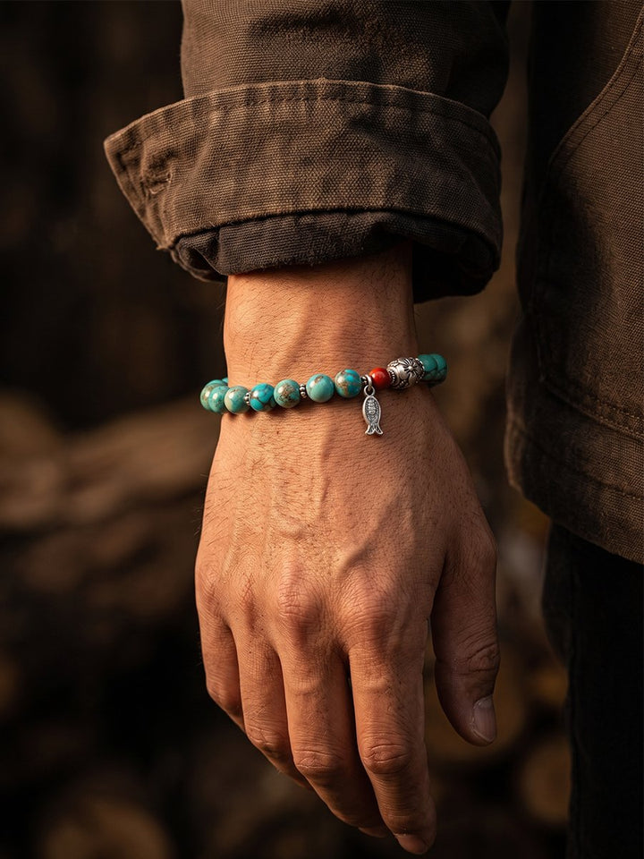 Man Wearing the Turquoise and Silver Fish Bracelet with a Canvas Jacket